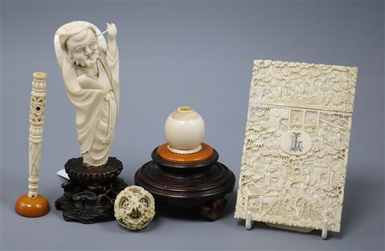 A carved ivory concentric ball on a hardwood, ivory and amber stand and two other items